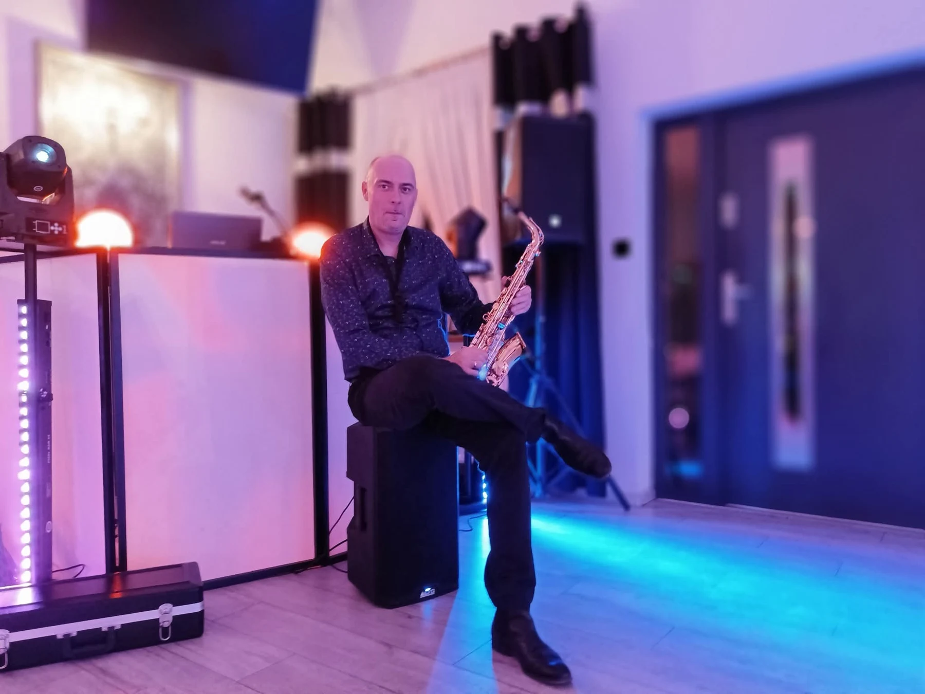 Sebastian przy stanowisku DJ-a z saksofonem